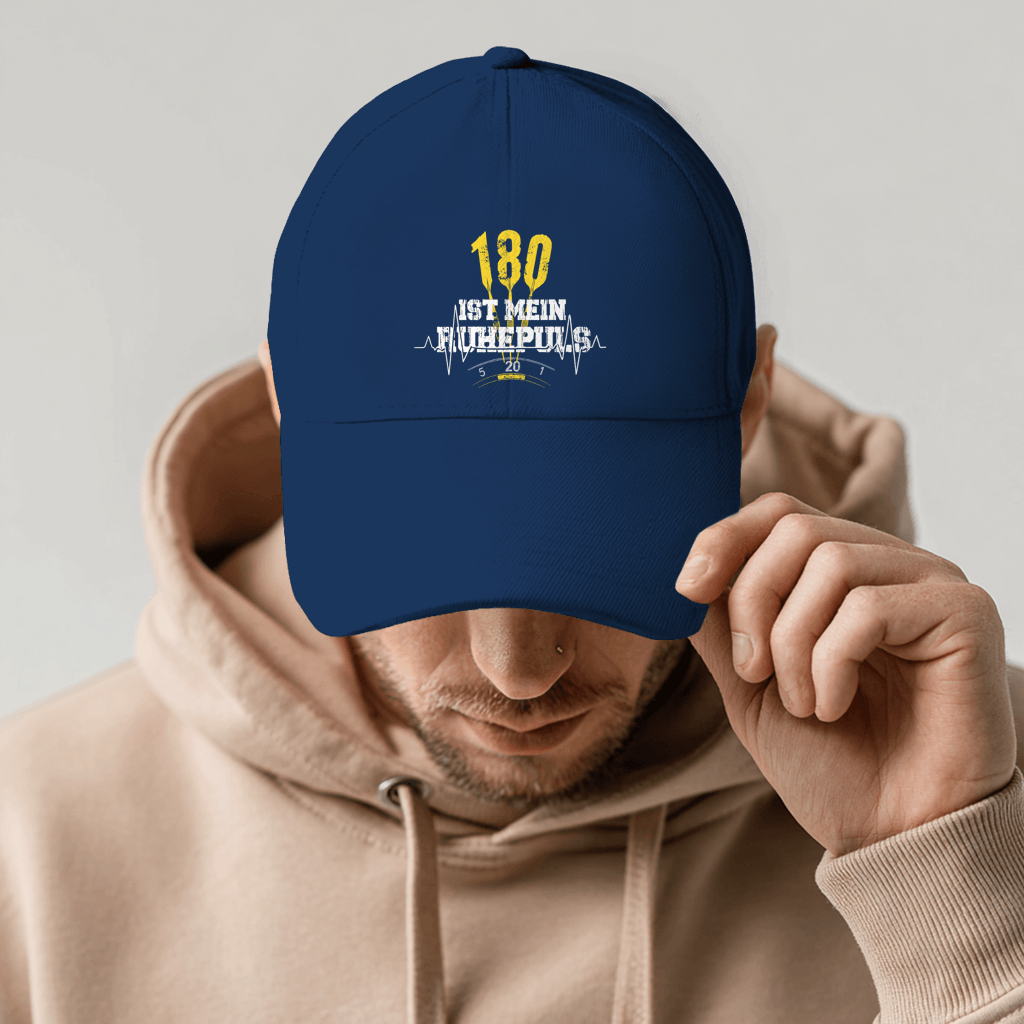 Person wearing a navy cap with the text '180 ist mein Ruhepuls' and dart-themed design.